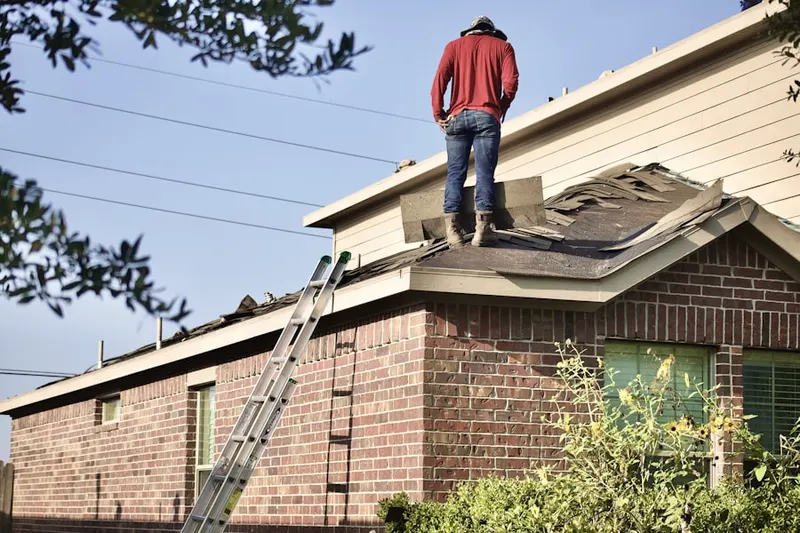 Professional roofer working on a residential roof in Laredo Highline